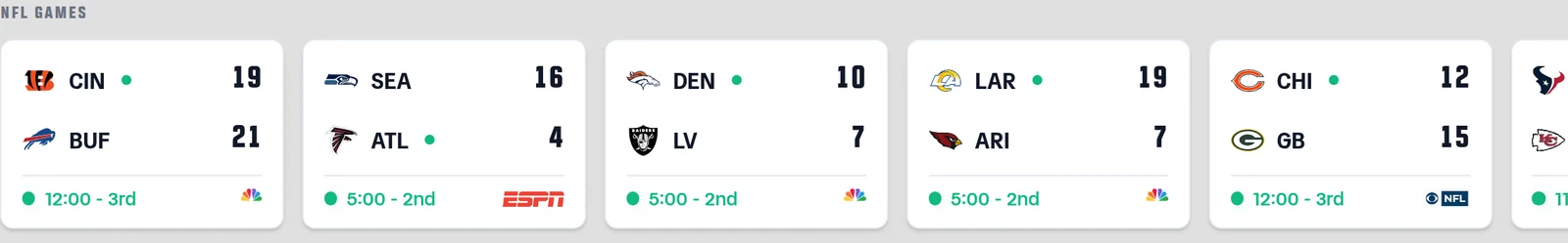 The NFL games rail on the Live Scoring page. Each game card shows the two teams with their logos and scores, the live clock along the bottom, and at the right of that same row the carrying network's logo — NBC's peacock, the ESPN wordmark, and the CBS NFL mark on separate cards.